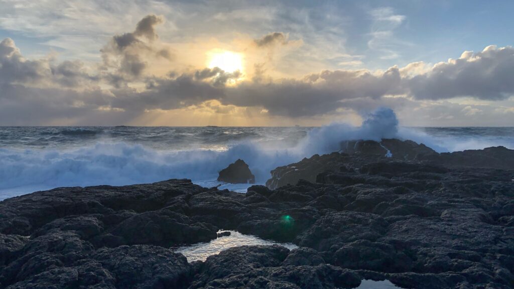 Waves crashing on a rocky beach, illustrating crisis communications.