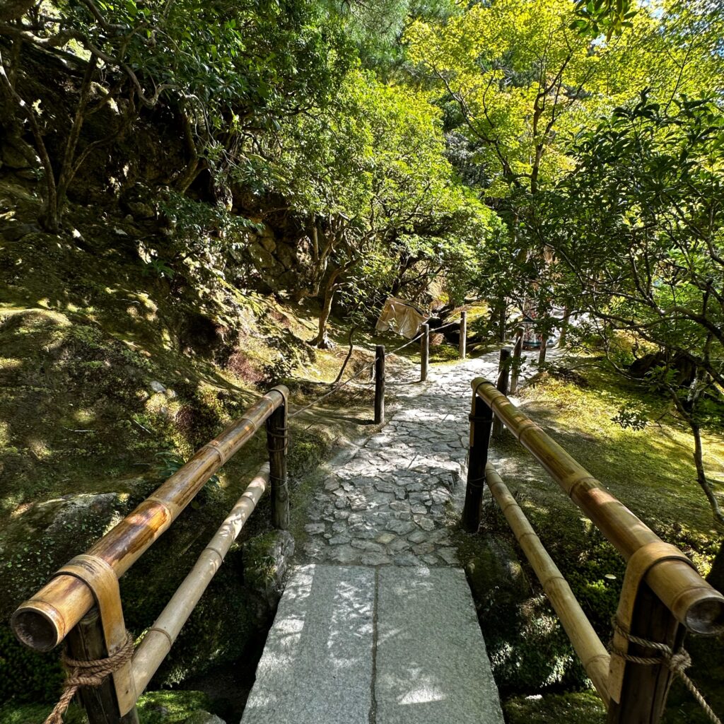 A bridge and green path in a Kyoto temple, illustrating the path to a successful tourism strategy.